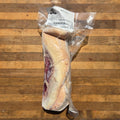 vacuum-sealed beef tongue, with a white label on a wooden surface
